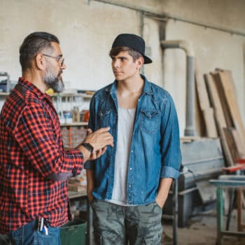 Father and Son able to communicate with each other about a project in their workshop