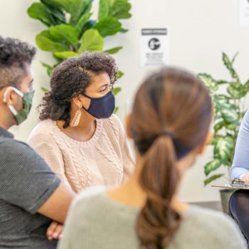 group leader discussing therapy plan with patients