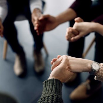 group holds hands at end of therapy session