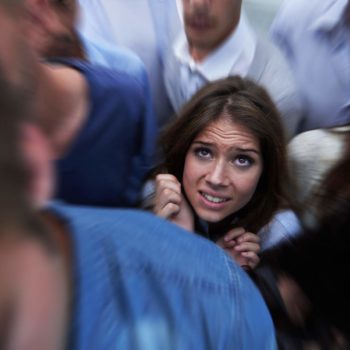 young woman afraid in a crowd
