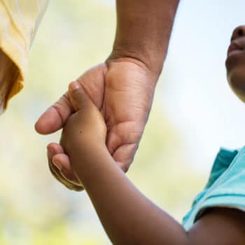 Child holding parents hand