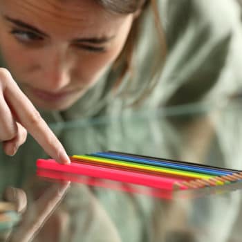 woman with Obsessive Compulsive Disorder lining up pencils so they are straight