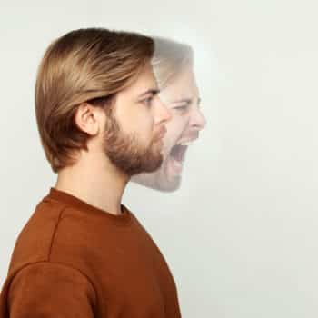 Profile side view portrait of two faced bearded man in calm serious and angry screaming expression. different emotion inside and outside mood of people. indoor studio shot, isolated on grey background. Creative photo representing a personality disorder.