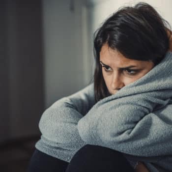 Close up of young woman struggling from multiple personality disorder.