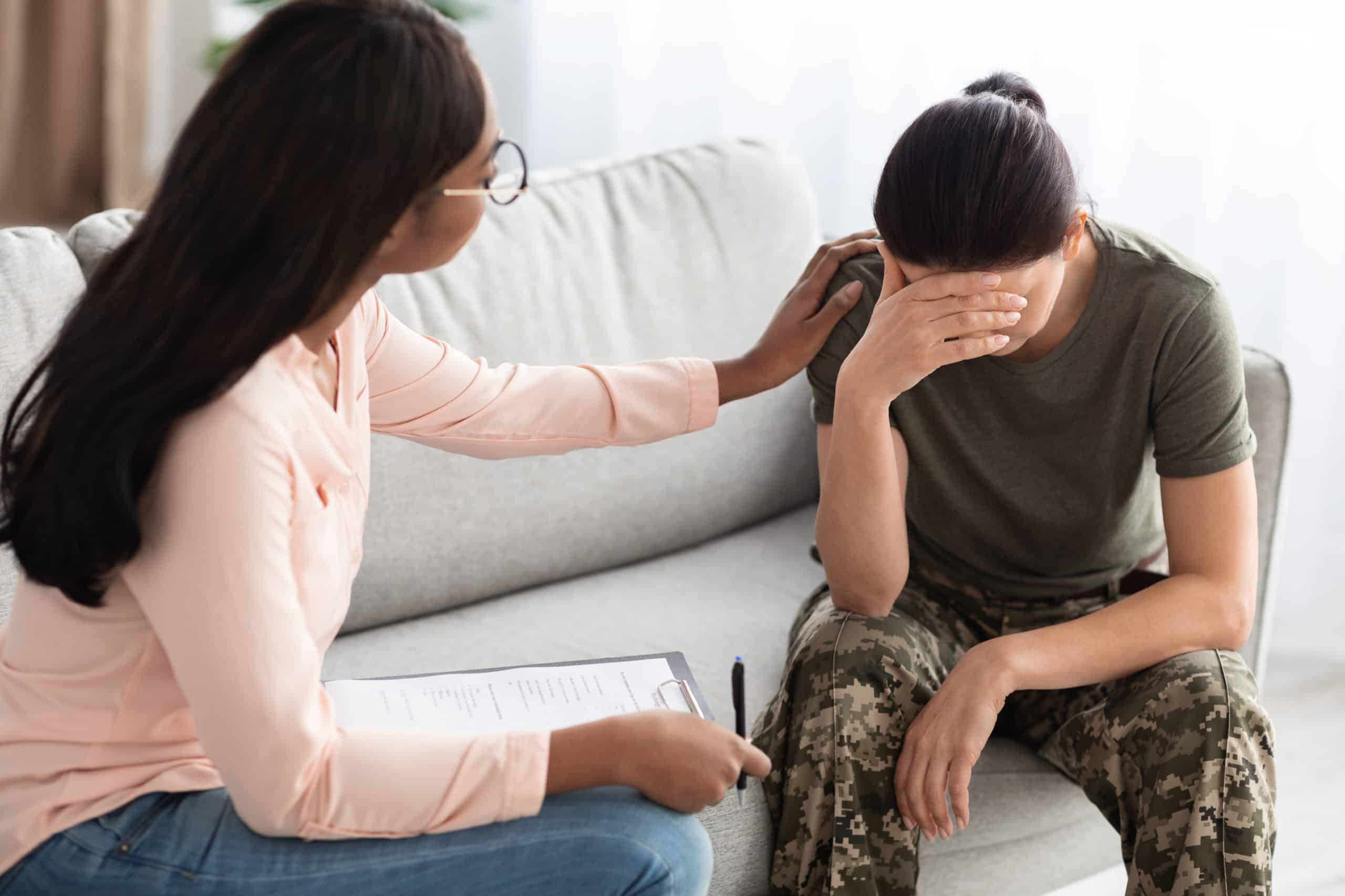 Black Psychologist Lady Comforting Soldier Woman In Uniform During Therapy Session
