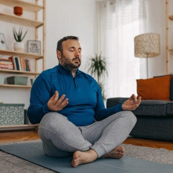 man meditating on the floor