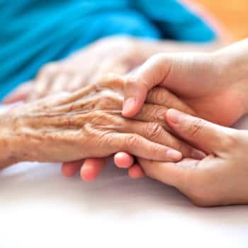 Daughter holder her mother's hands.