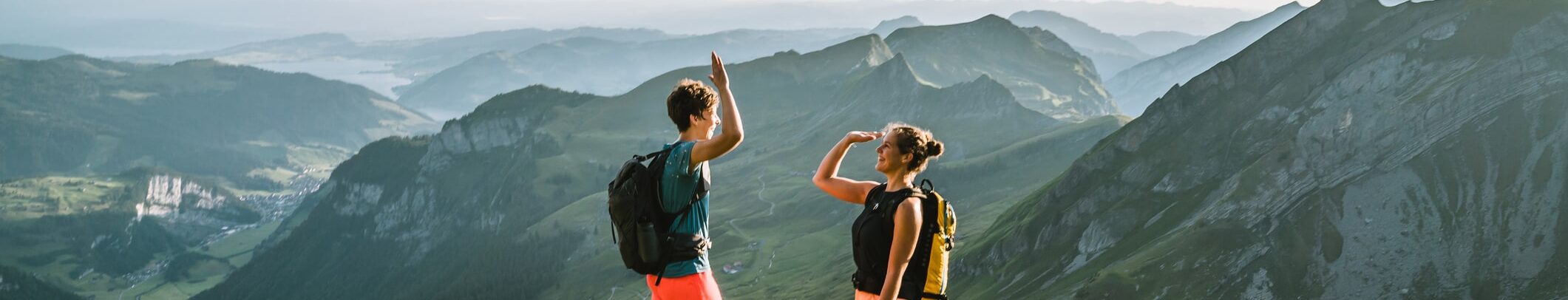Trail runners ascend high mountain ridge